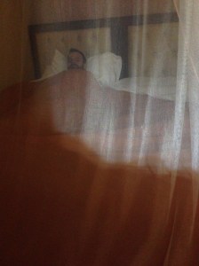 Tim sleeping under mosquito net 